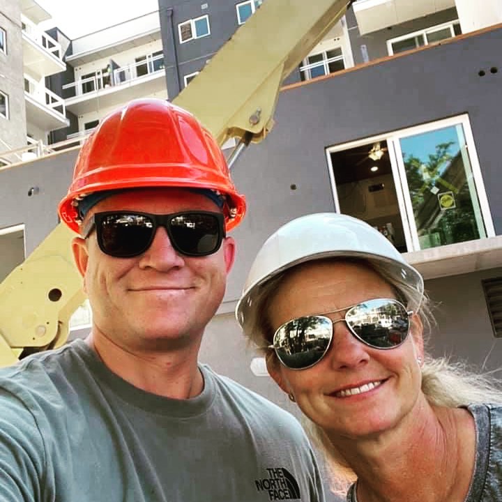 Melanie Stezzi and a colleague wearing hard hats on a jobsite