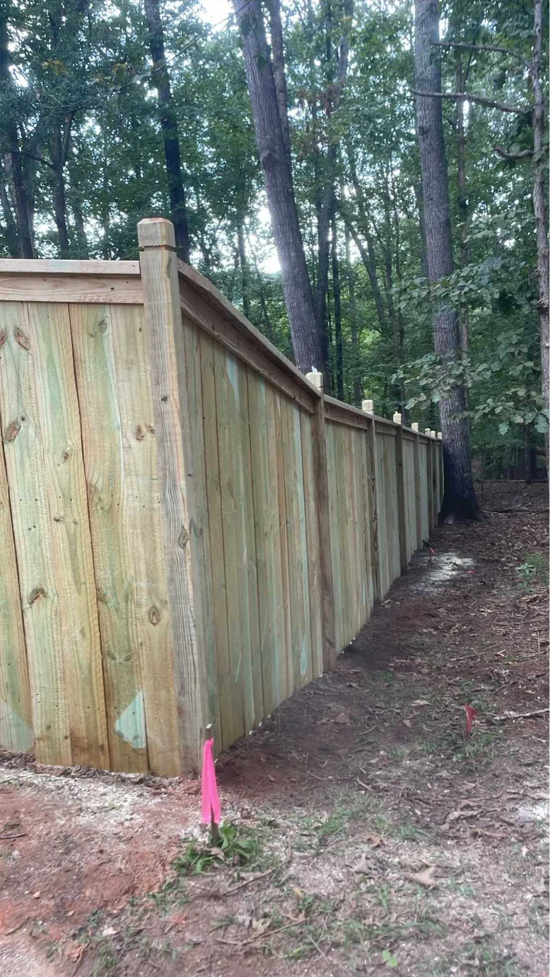 Six-foot capped wood privacy fence featuring custom dado posts in Alpharetta