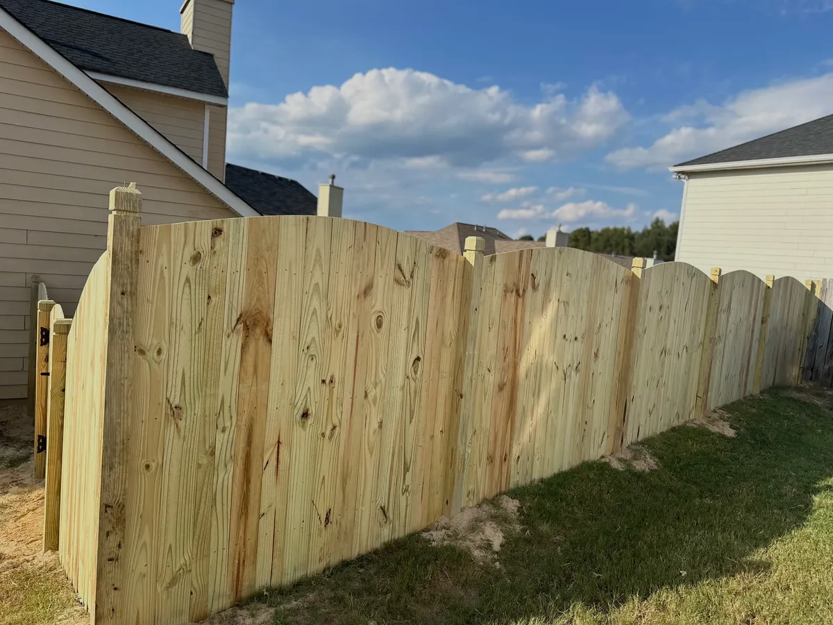 Six-foot positive scalloped wood privacy fence with decorative dado posts in Peachtree Corners
