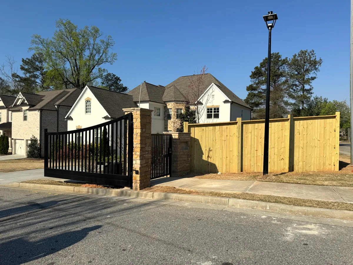 Luxury HOA neighborhood entrance estate gate and perimeter fence on Parsons Road in Johns Creek