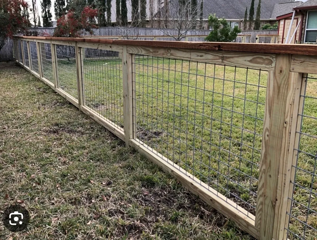 Modern wood-framed hog wire grid panel fence along property slope in Marietta GA